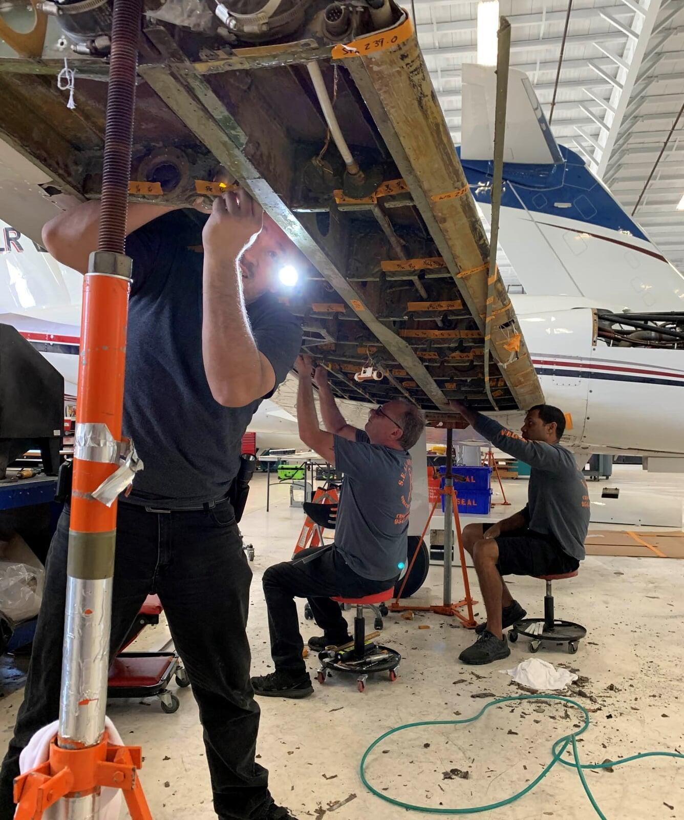 Fuel tank and structures teams working together replacing lower wing skin