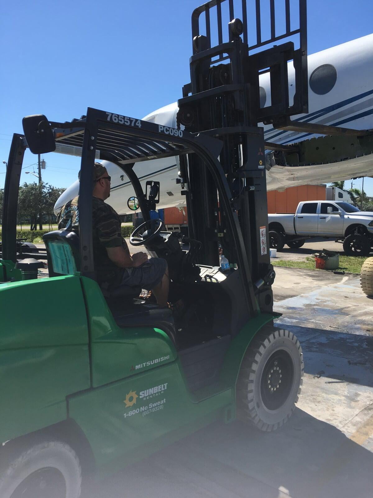 SEAL Aviation loads a section of aircraft onto a trailer for disposal