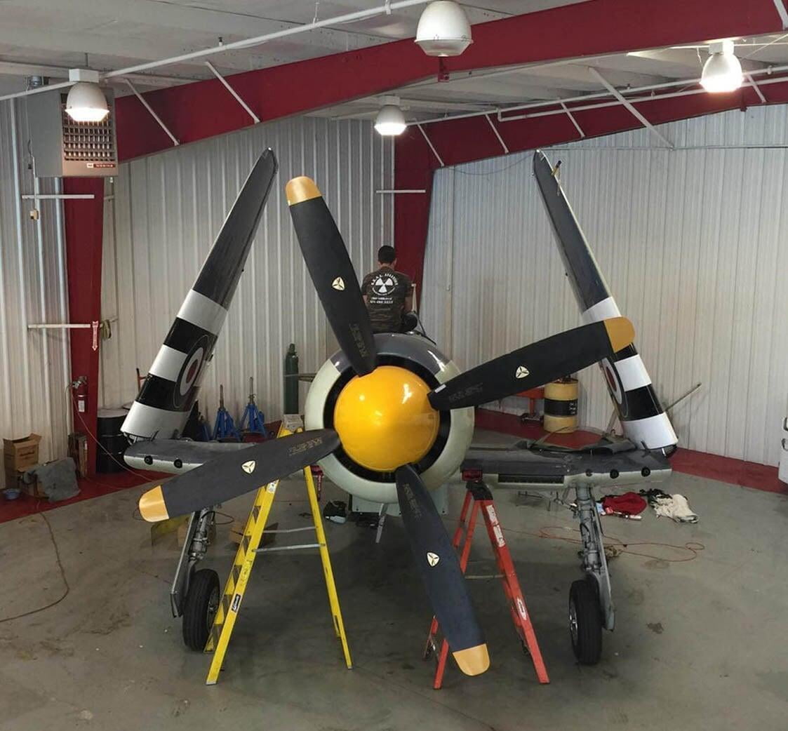 A SEAL Aviation Technician assisting with repairs on a Hawker Sea Fury