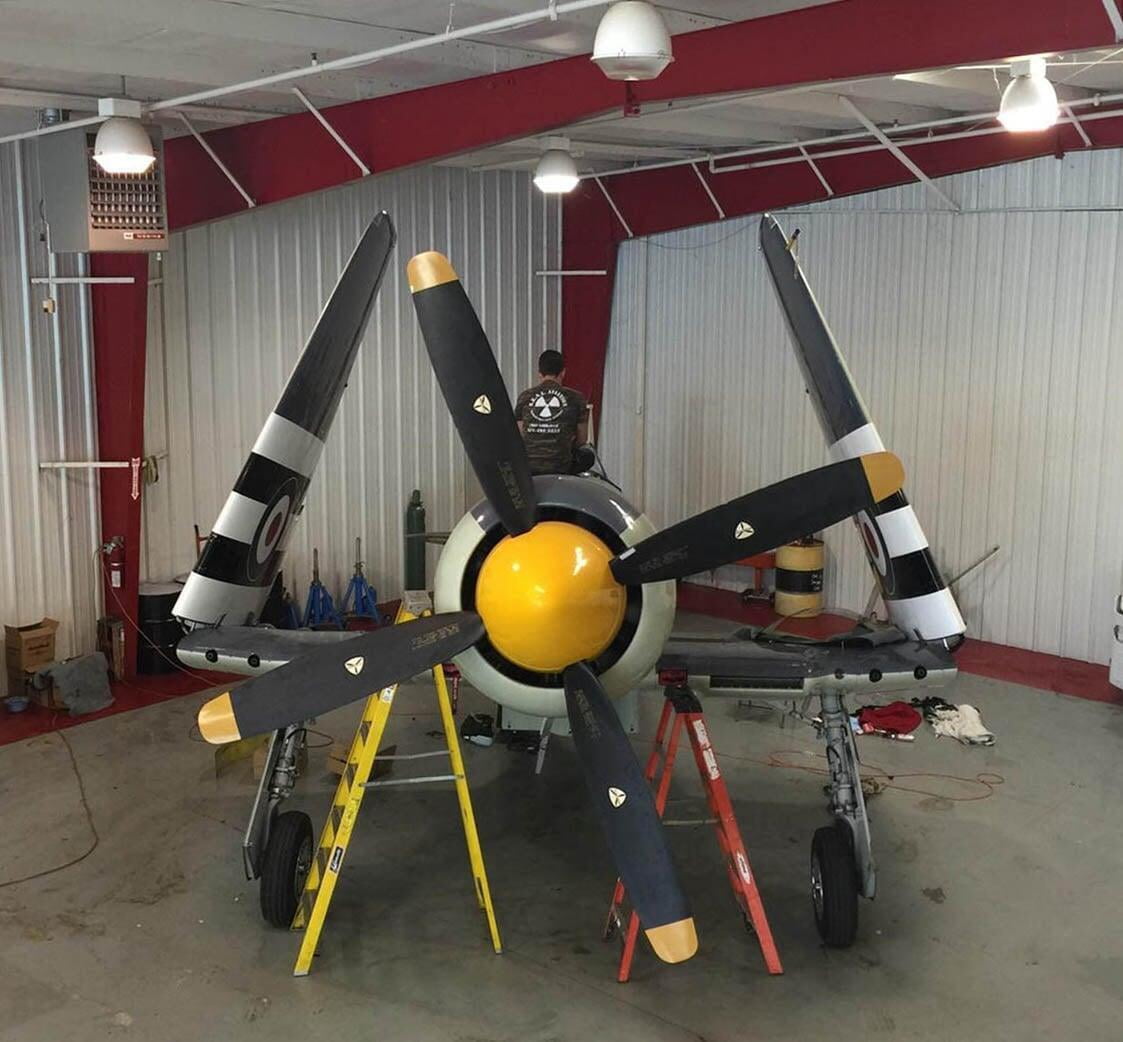 A SEAL Aviation Technician assisting with repairs on a Hawker Sea Fury 