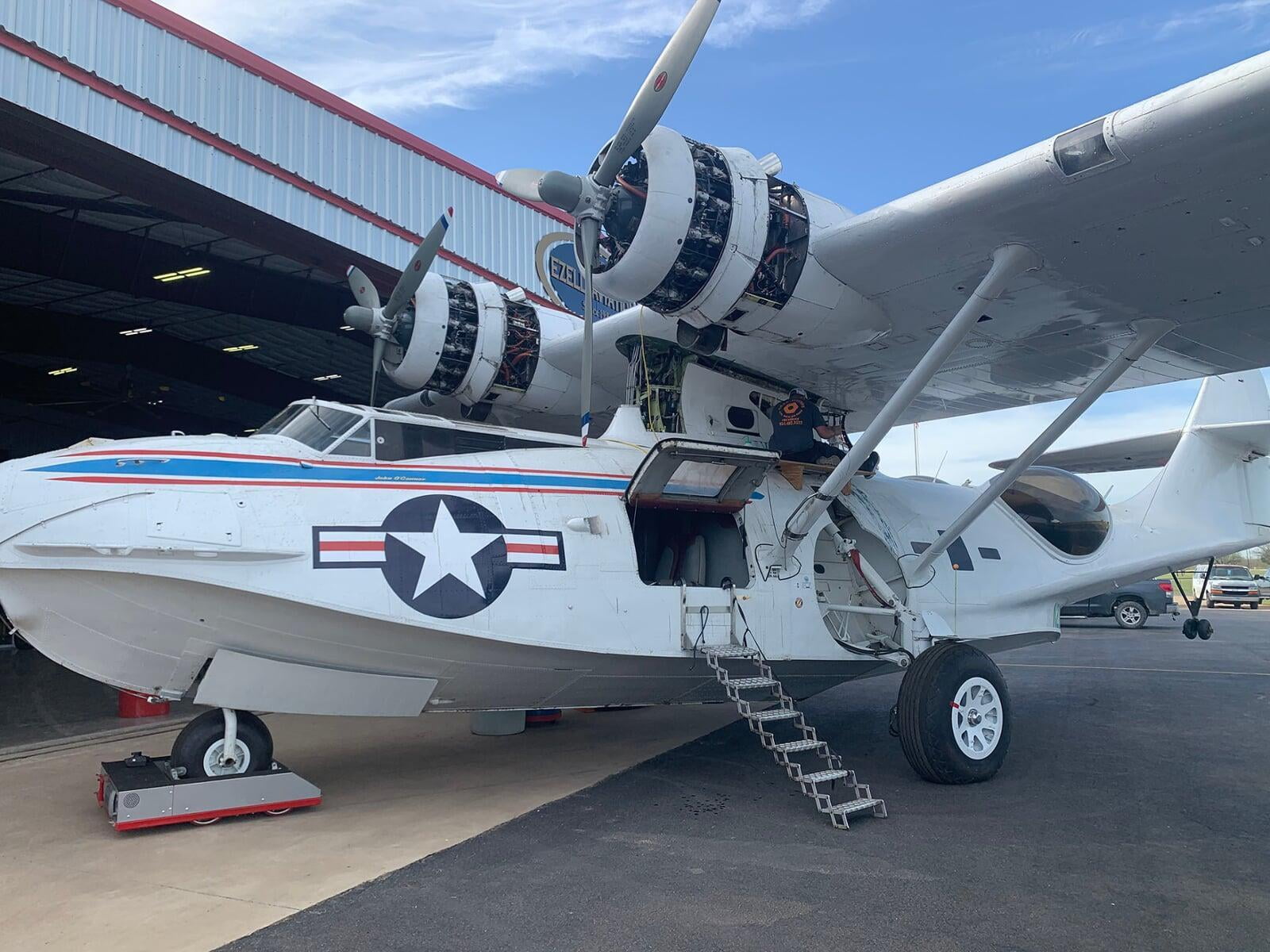 SEAL Aviation Technicians repairing fuel leaks on a Consolidated PBY Catalina. This amphibious aircraft has a rich military history serving in various branches of the US Armed Forces.