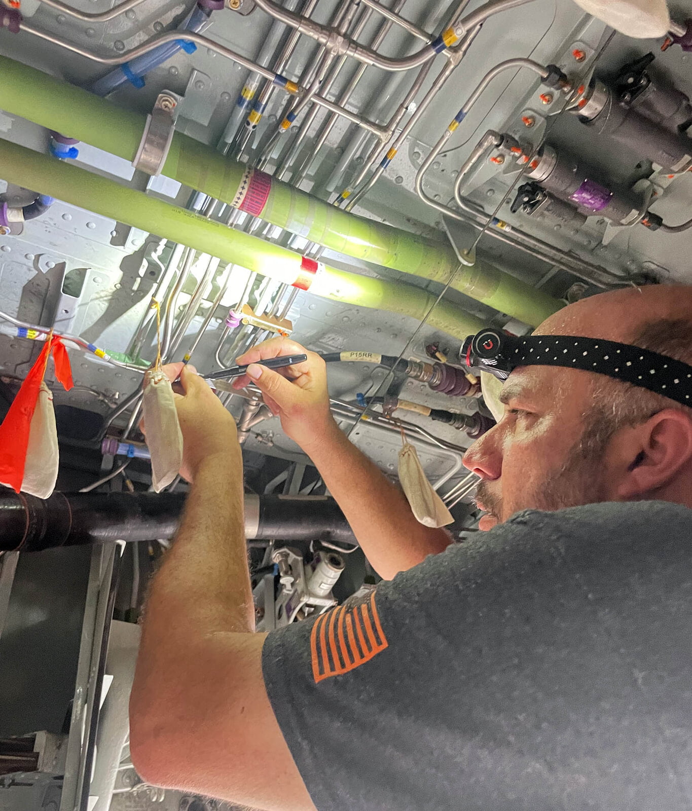 A SEAL Aviation Technician Permaswaging lines for a Challenger