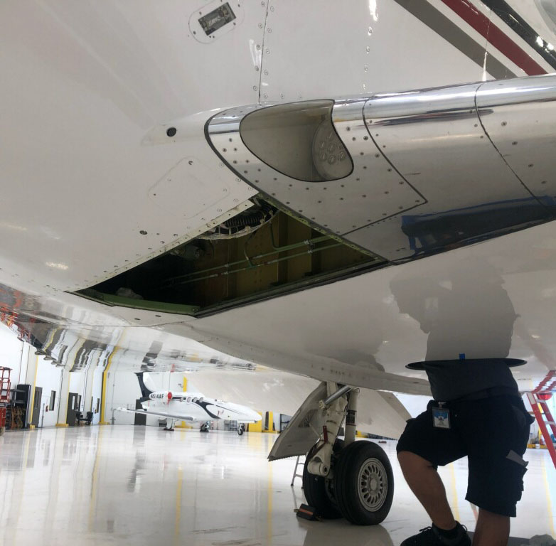 A SEAL Aviation Fuel Leak Repair Tech inspecting a Gulfstream G-450
